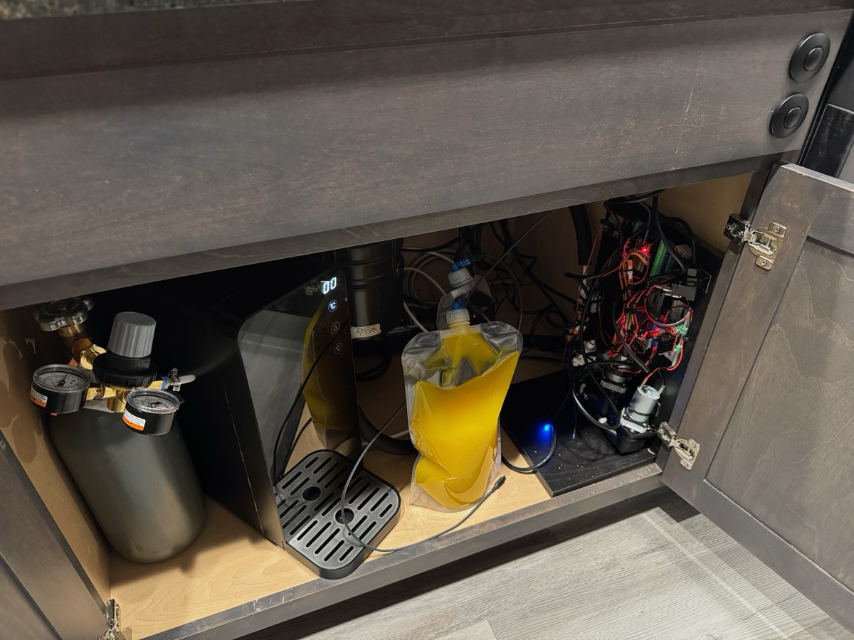 The prototype installed under the kitchen sink, pouring.