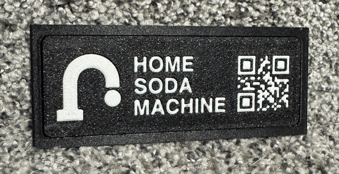 The first printed nameplate: the new faucet mark, HOME SODA MACHINE, and a QR code for the unit's own page.